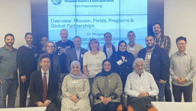 Group photo of MENA Space Leaders visit, posing in front of a large presentation screen.